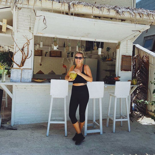 Bersantai di pantai sambil minum air kelapa